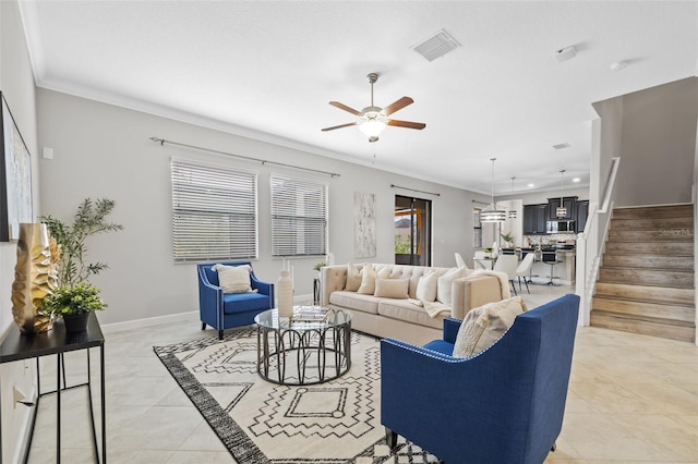 living room with light tile patterned floors, visible vents, ornamental molding, baseboards, and stairs