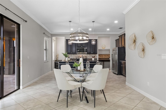 dining space featuring baseboards, ornamental molding, and light tile patterned flooring