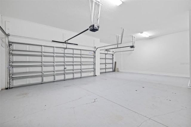 garage featuring baseboards and a garage door opener