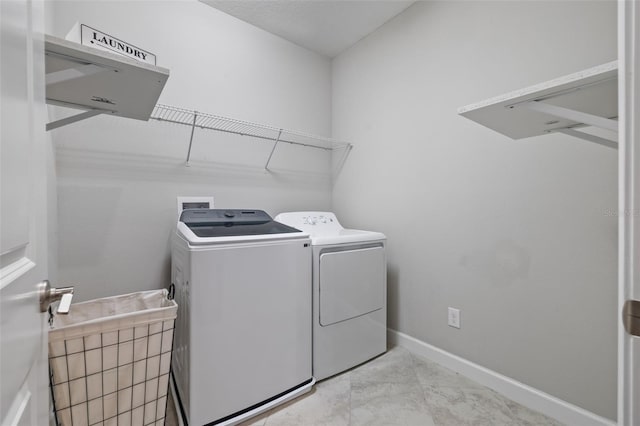 laundry area with laundry area, baseboards, and independent washer and dryer