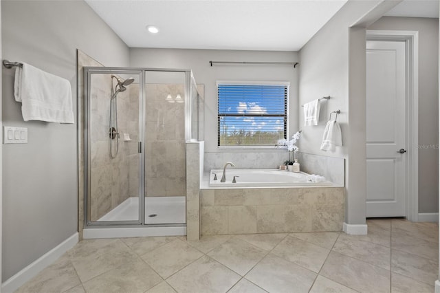 bathroom featuring a shower stall, baseboards, a bath, and tile patterned floors