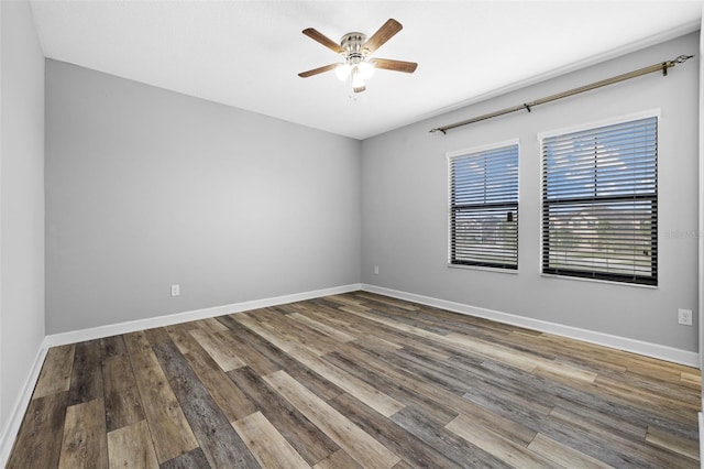 unfurnished room featuring a ceiling fan, baseboards, and wood finished floors