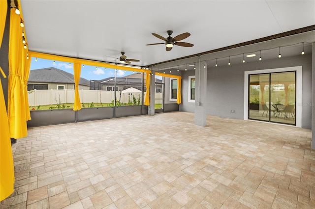 view of patio / terrace featuring fence and a ceiling fan