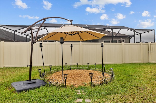 view of yard featuring a lanai and a fenced backyard