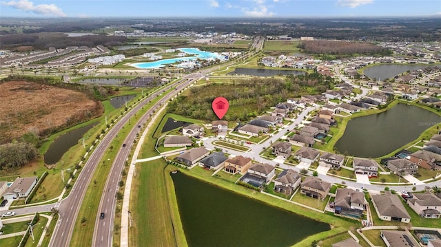 birds eye view of property with a water view and a residential view