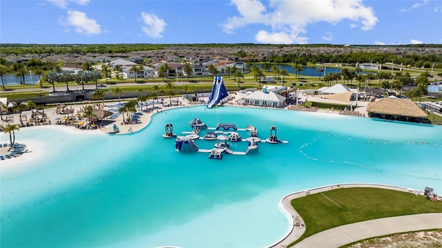 view of pool featuring a residential view and a water view