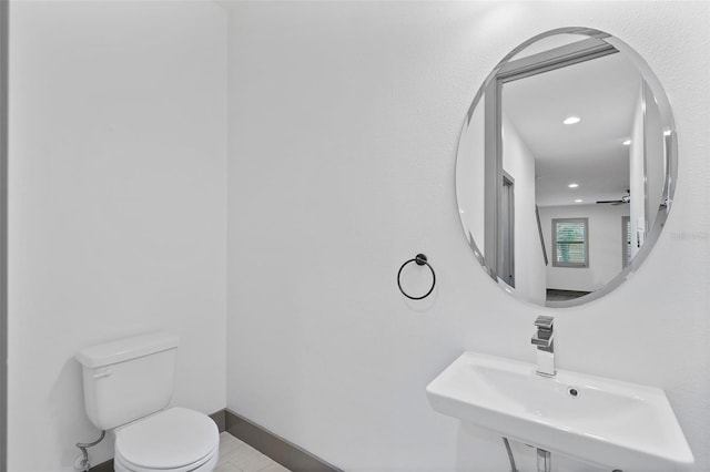 1110 25th St N, Saint Petersburg, FL 33713 - half bath featuring toilet, baseboards, and a sink