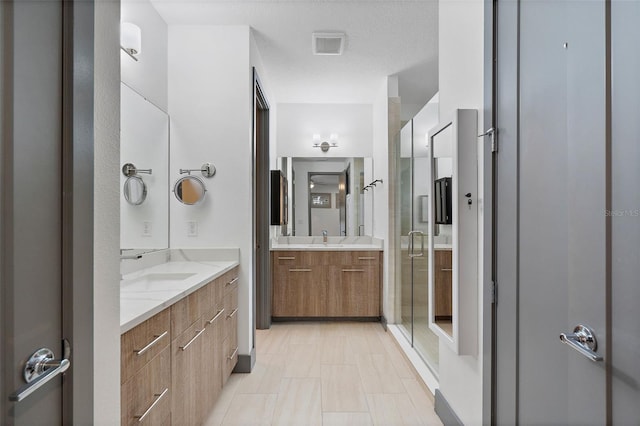 1110 25th St N, Saint Petersburg, FL 33713 - bathroom featuring visible vents, two vanities, a sink, and a shower stall