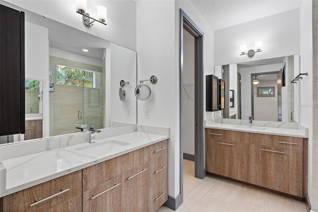 1110 25th St N, Saint Petersburg, FL 33713 - bathroom with two vanities, a sink, a ceiling fan, and a shower stall