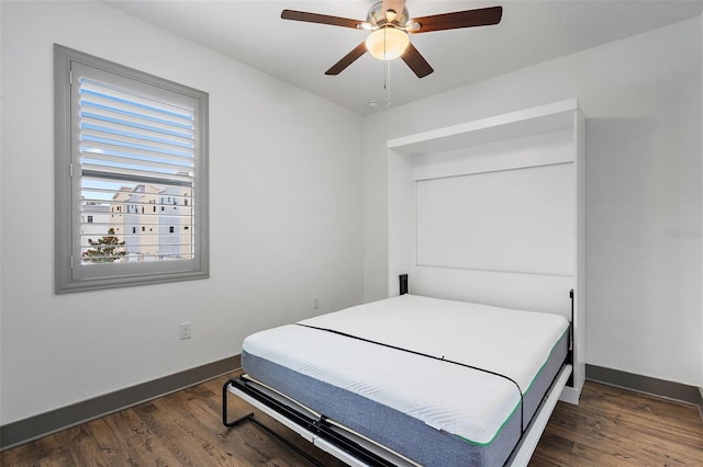 1110 25th St N, Saint Petersburg, FL 33713 - bedroom with dark wood-style floors, ceiling fan, and baseboards
