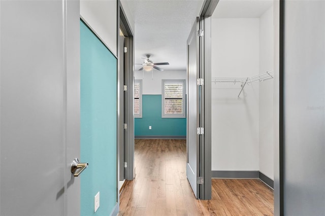 1110 25th St N, Saint Petersburg, FL 33713 - hall featuring a textured ceiling, light wood finished floors, and baseboards