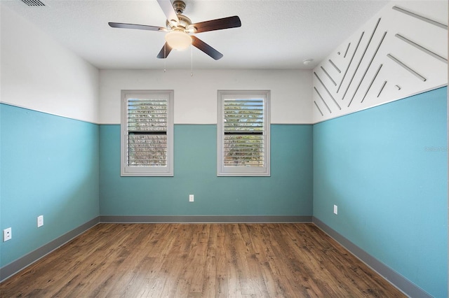 1110 25th St N, Saint Petersburg, FL 33713 - unfurnished room with a ceiling fan, a textured ceiling, baseboards, and wood finished floors