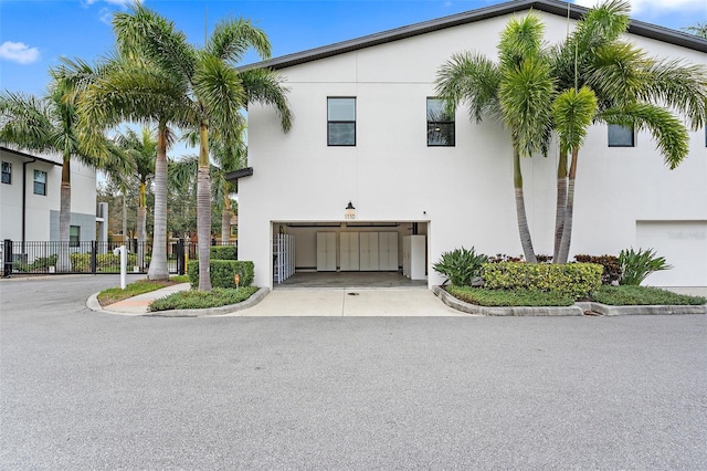 1110 25th St N, Saint Petersburg, FL 33713 - view of front of home featuring driveway, an attached garage, fence, and stucco siding