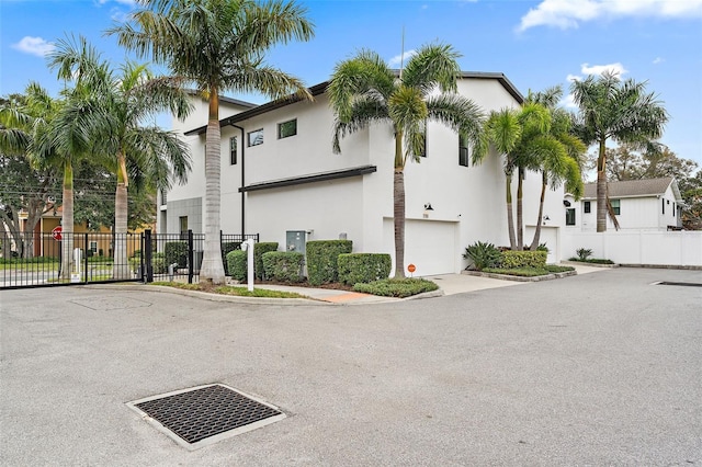 1110 25th St N, Saint Petersburg, FL 33713 - view of front of home with a garage, fence, and stucco siding