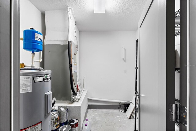 1110 25th St N, Saint Petersburg, FL 33713 - exercise area with electric water heater and a textured ceiling