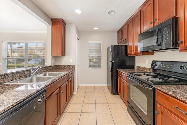 kitchen featuring a healthy amount of sunlight, black appliances, a sink, and light tile patterned flooring