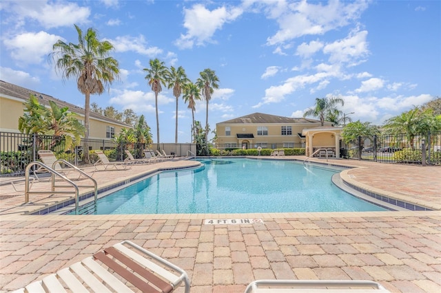 pool featuring a patio area and fence