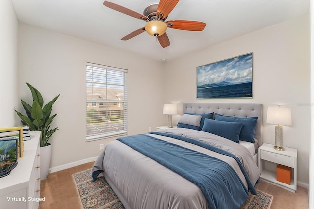 bedroom featuring light carpet, ceiling fan, and baseboards