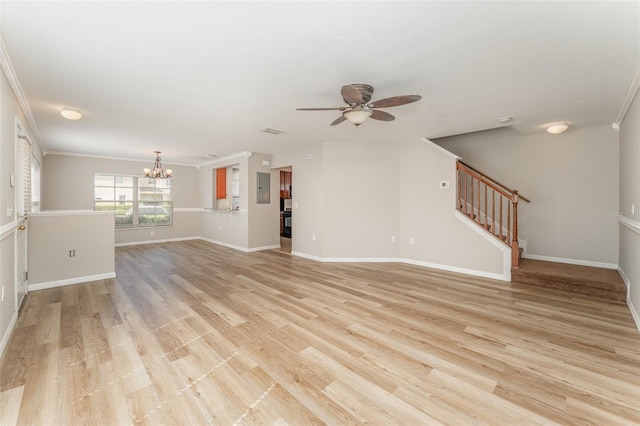 unfurnished living room featuring ceiling fan with notable chandelier, baseboards, light wood-style floors, ornamental molding, and stairway