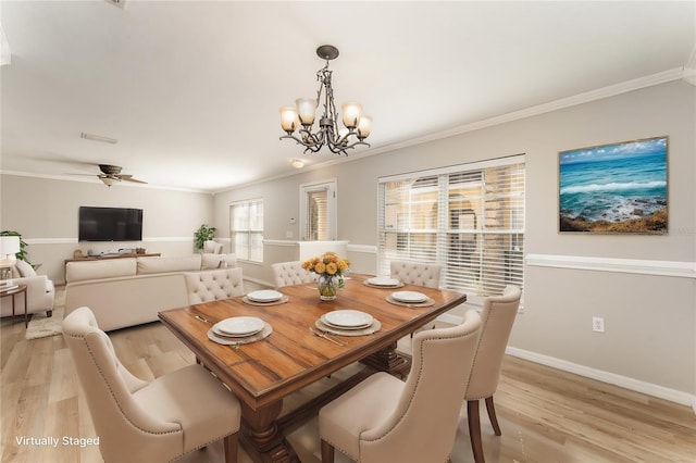 dining area featuring crown molding, light wood-style flooring, baseboards, and ceiling fan with notable chandelier