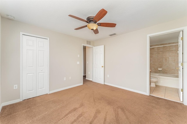 unfurnished bedroom featuring a closet, carpet flooring, visible vents, and baseboards