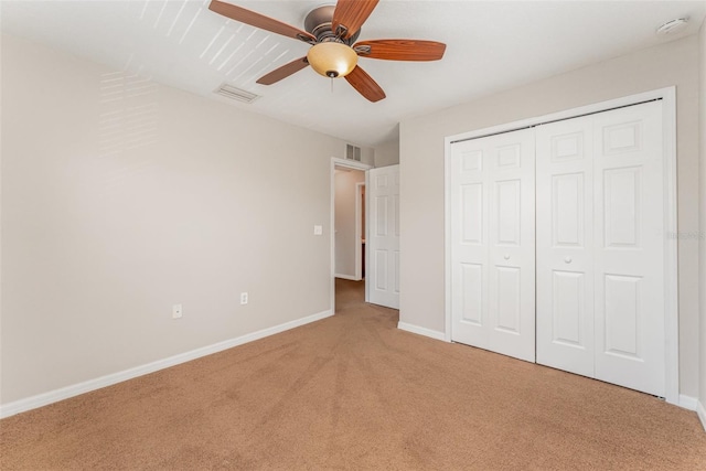 unfurnished bedroom featuring light carpet, baseboards, visible vents, and a closet