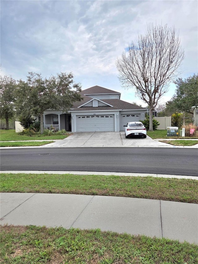 exterior space featuring a garage, concrete driveway, and stucco siding