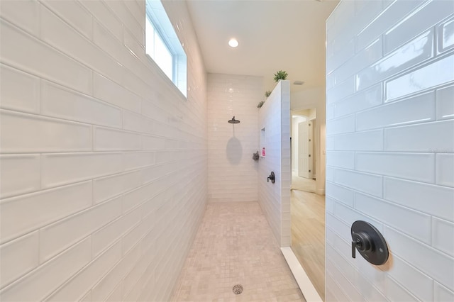 bathroom with tiled shower and recessed lighting