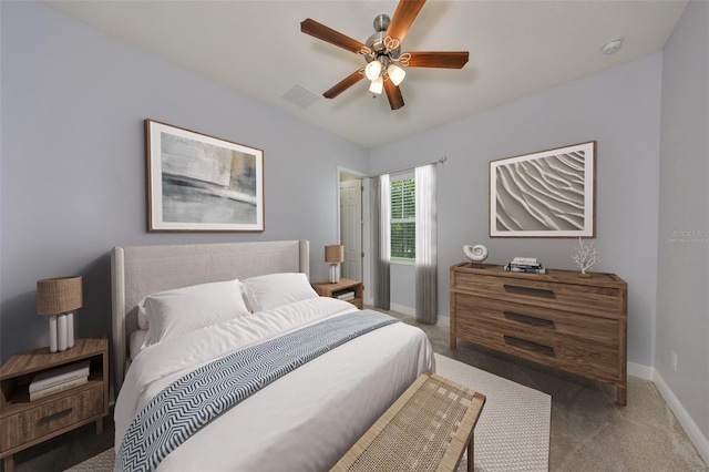 bedroom featuring visible vents, baseboards, dark colored carpet, and a ceiling fan