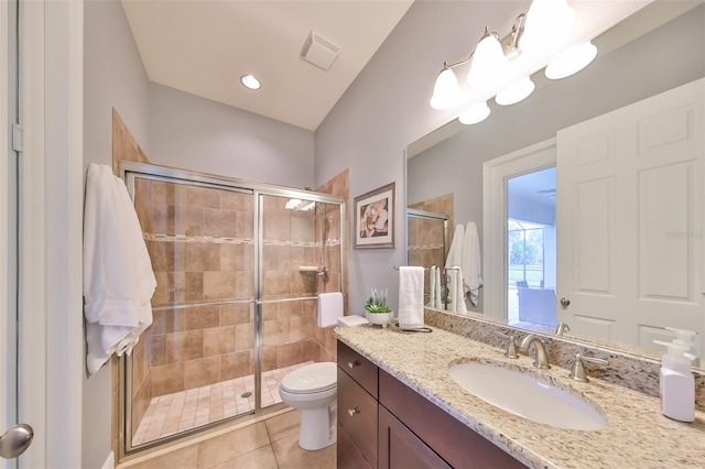 full bathroom featuring visible vents, toilet, tile patterned floors, vanity, and a shower stall