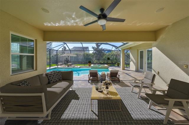 view of patio featuring glass enclosure, a pool with connected hot tub, an outdoor hangout area, and a ceiling fan