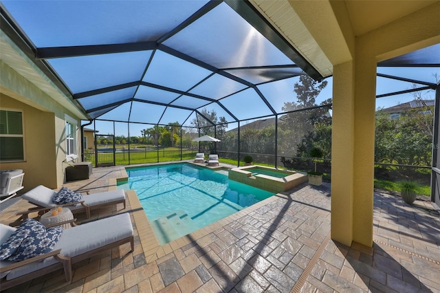 view of pool with a lanai, a patio area, and a pool with connected hot tub