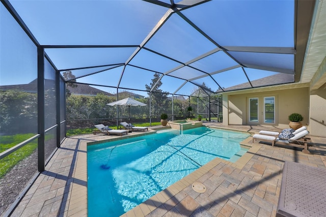 view of pool featuring a patio area, a lanai, and a pool with connected hot tub