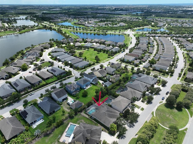 bird's eye view with a water view and a residential view