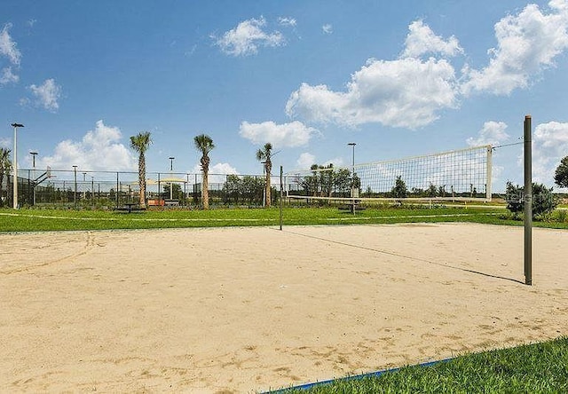 view of home's community with fence and volleyball court