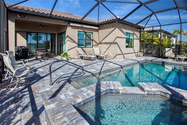 view of swimming pool featuring a lanai, a patio area, and a ceiling fan