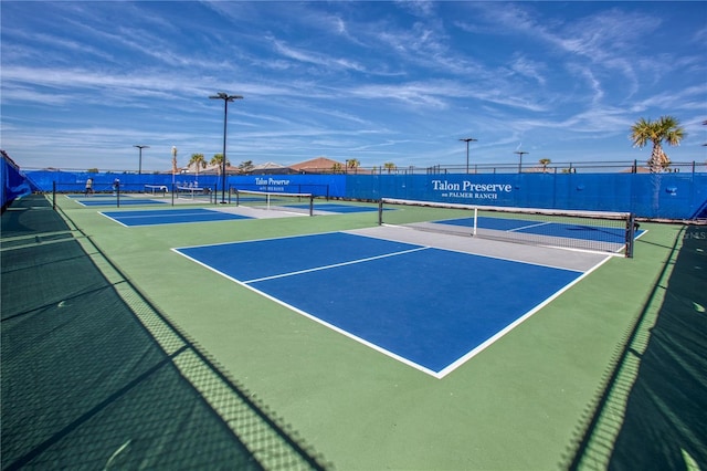 view of sport court featuring a water view