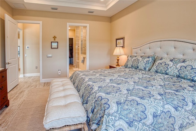 bedroom with ornamental molding, light wood-type flooring, visible vents, and baseboards