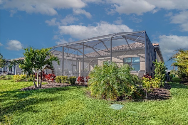 view of yard with glass enclosure