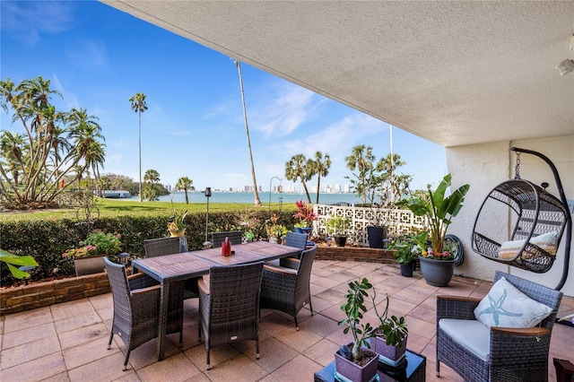 view of patio featuring outdoor lounge area, outdoor dining area, and a water view