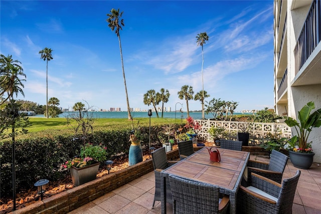 view of patio featuring outdoor dining space and a water view