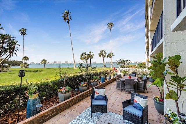 view of patio featuring outdoor dining space and a water view