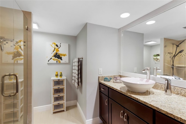 bathroom with tile patterned flooring, recessed lighting, vanity, baseboards, and a stall shower