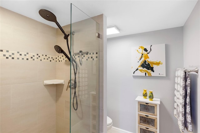 bathroom with a tile shower and toilet