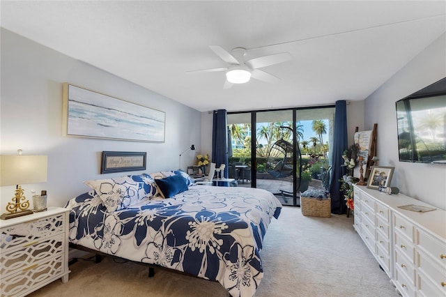 bedroom featuring expansive windows, light carpet, a ceiling fan, and access to exterior