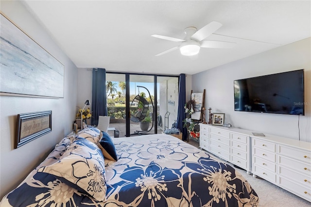 bedroom with a wall of windows, access to exterior, light carpet, and ceiling fan