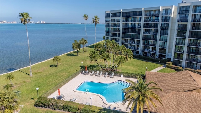 pool featuring a patio area and a water view