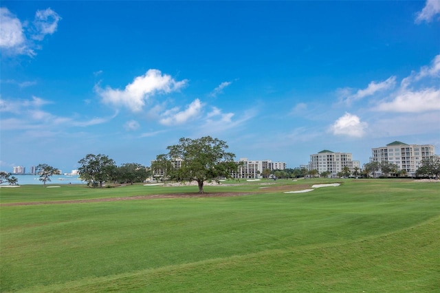 view of community featuring a lawn and golf course view