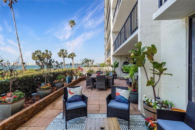 view of patio featuring a balcony, outdoor dining area, and outdoor lounge area