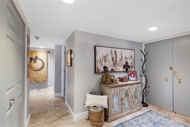 foyer entrance featuring recessed lighting and baseboards